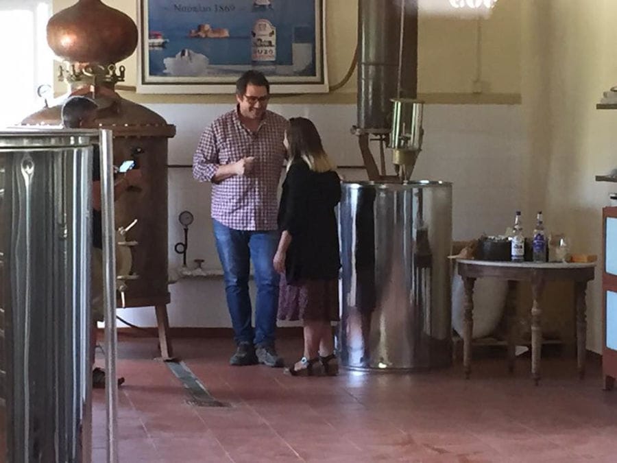 a couple smiling and discussing by the part of copper Karonis Distillery